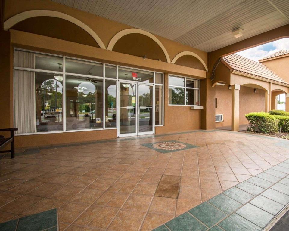 an empty lobby of a building with glass doors at Quality Inn Alachua - Gainesville Area in Alachua