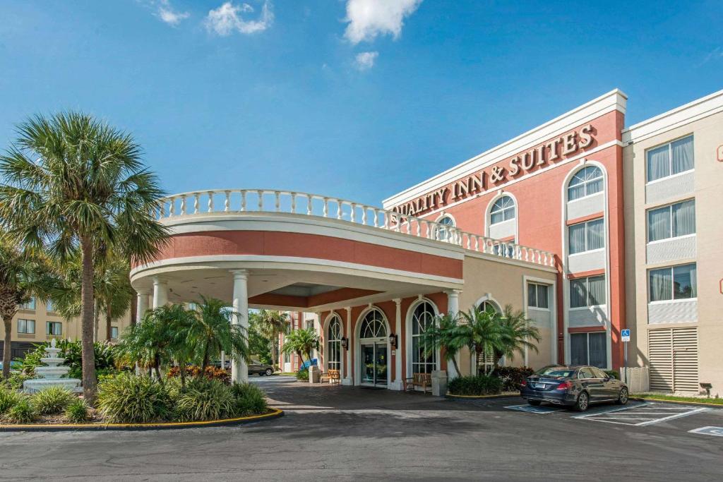
a large building with a large clock on the front of it at Quality Inn & Suites Near the Theme Parks in Orlando
