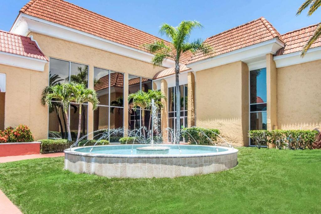 a house with a fountain in the yard at Quality Inn and Suites Conference Center in New Port Richey