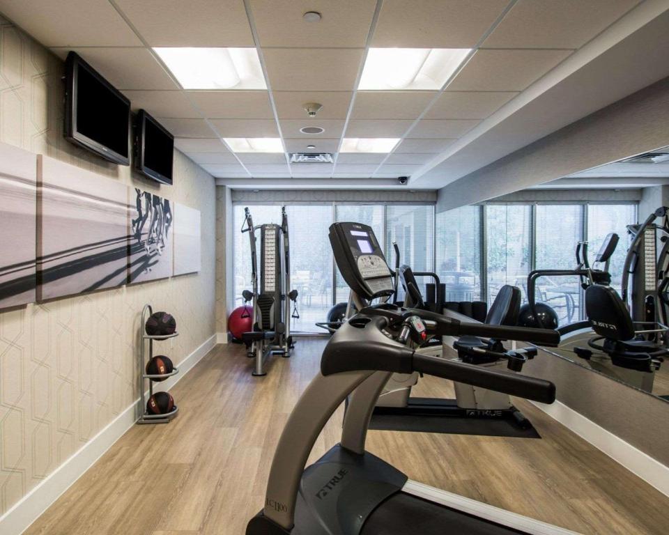 a gym with several tread machines in a room at Comfort Suites Miami Airport North in Miami