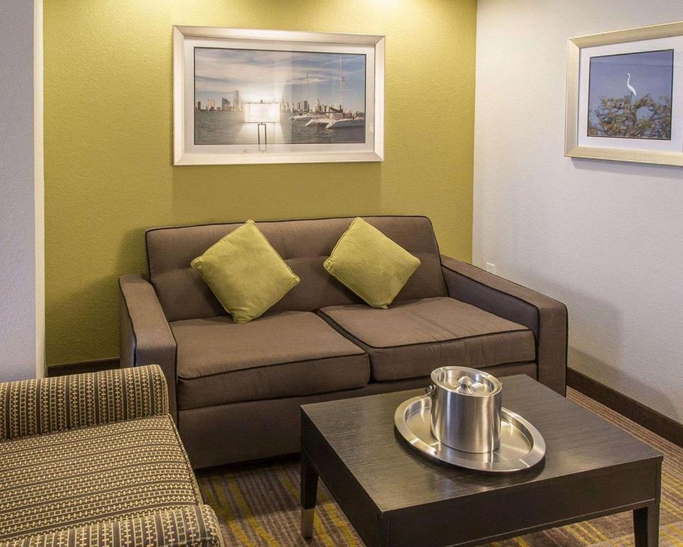 a living room with a couch and a table at Comfort Suites Miami Airport North in Miami