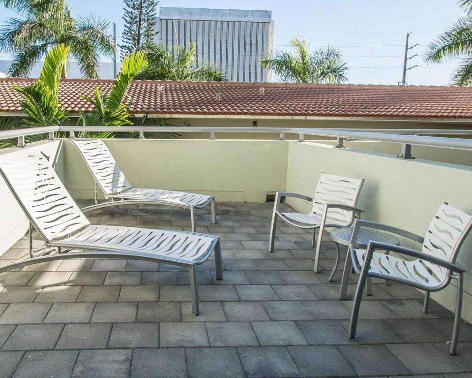 a group of chairs and tables on a patio at Comfort Suites Miami Airport North in Miami