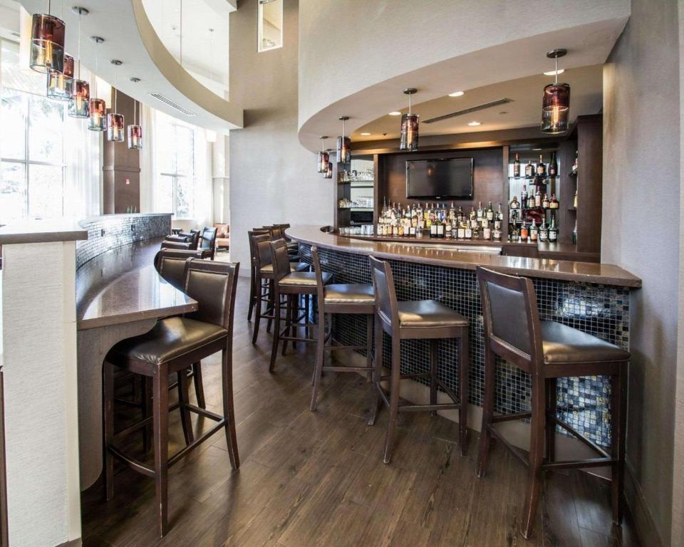 a bar with brown stools in a restaurant at Comfort Suites Miami Airport North in Miami
