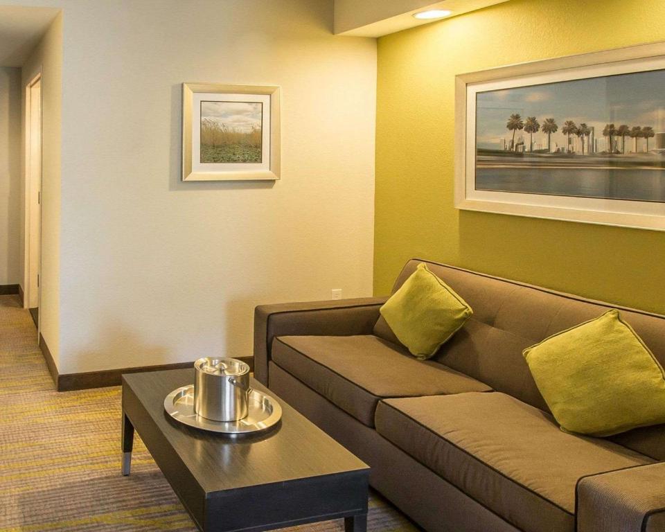 a living room with a couch and a table at Comfort Suites Miami Airport North in Miami