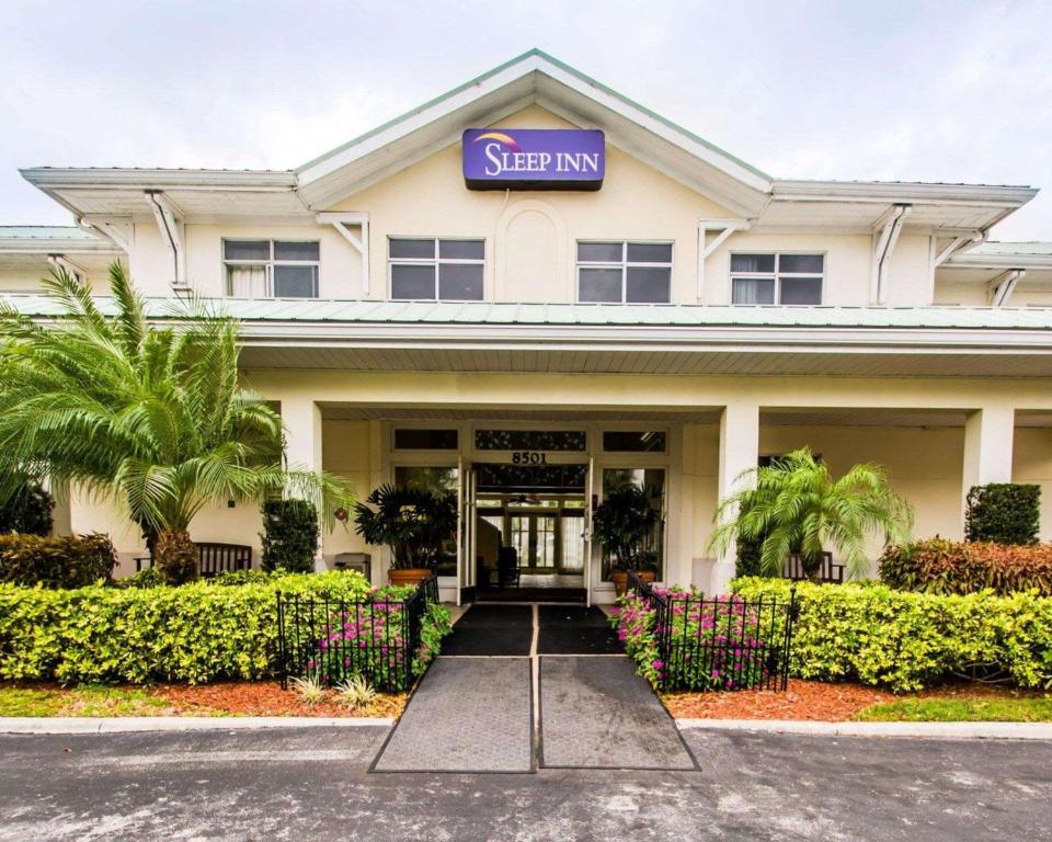 a hotel with a sign on the front of it at Sleep Inn at PGA Village in Port Saint Lucie
