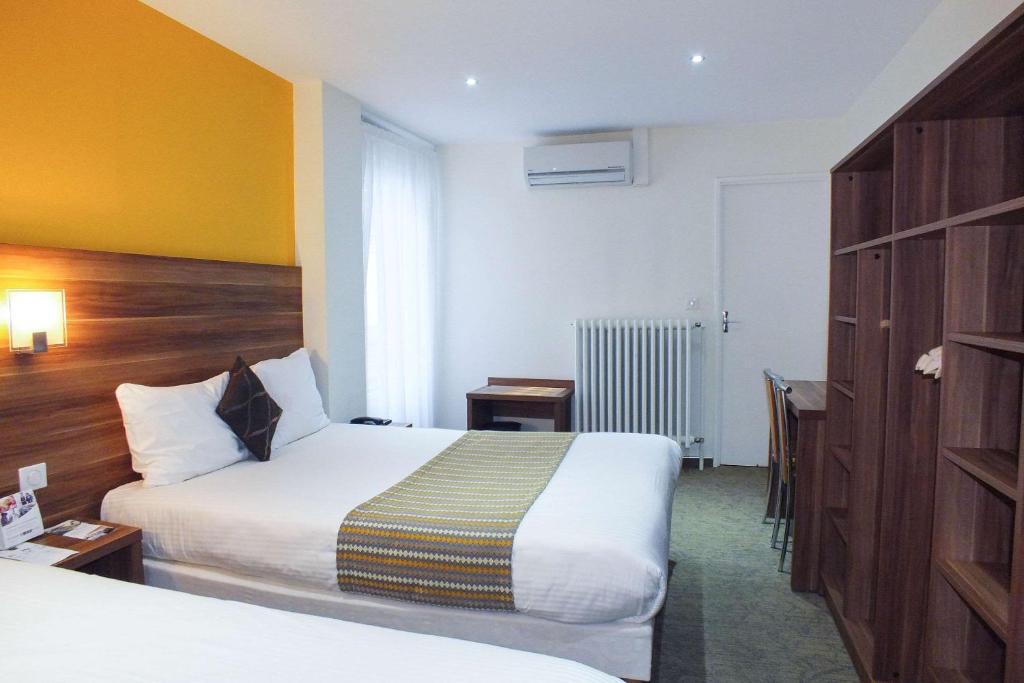 Postel nebo postele na pokoji v ubytování Hotel Cecil Metz Gare