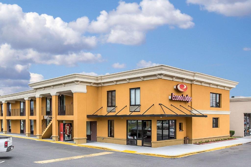 a large yellow building with a sign on it at Econo Lodge Midtown in Savannah