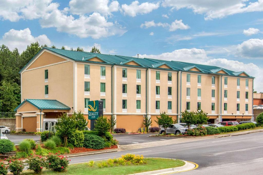 a large white building with a green roof at Quality Inn & Suites Union City - Atlanta South in Union City