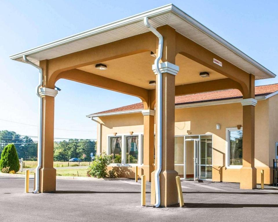 a large building with awning in a parking lot at Quality Inn & Suites in Cartersville