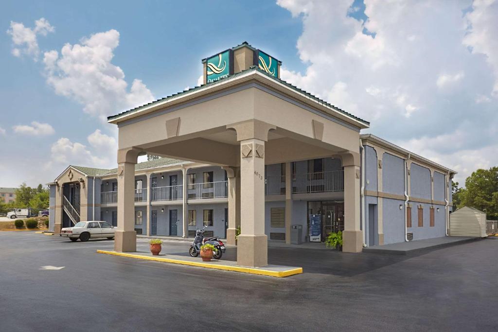 a large building with a parking lot in front of it at Quality Inn Augusta West Near Fort Eisenhower in Augusta