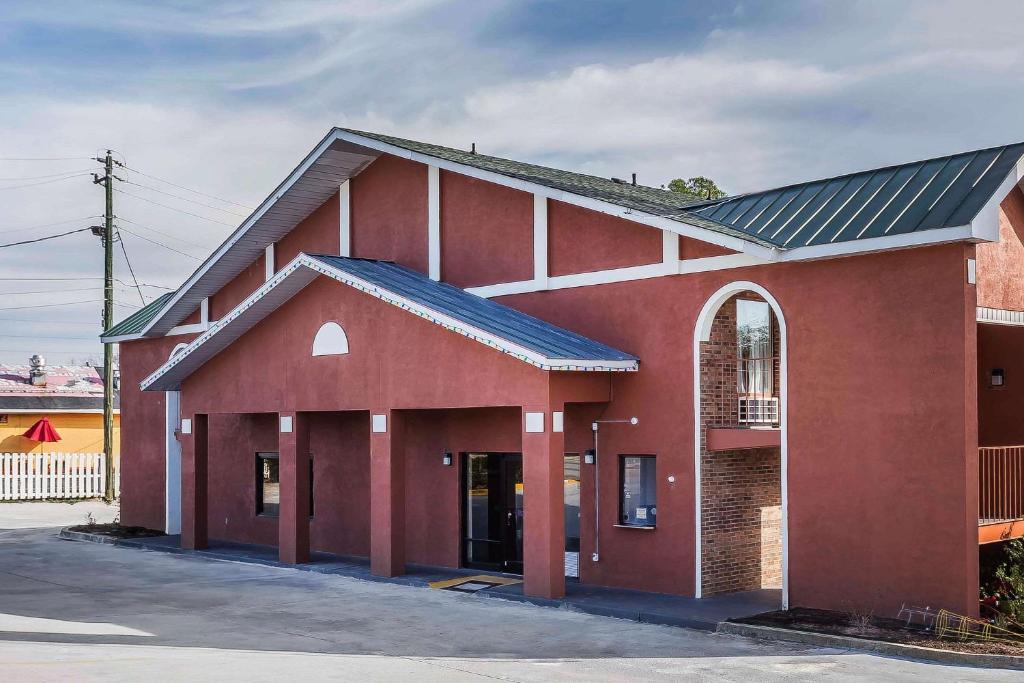 a red brick building with a black roof at Rodeway Inn in Augusta