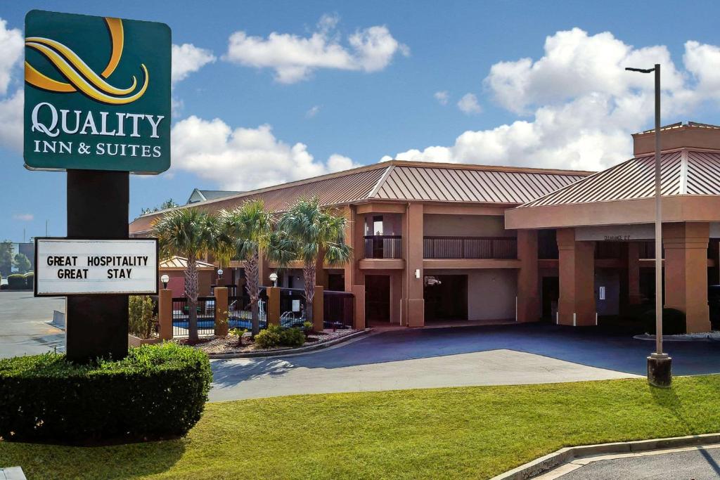 a quality inn and suites sign in front of a building at Quality Inn & Suites near Robins Air Force Base in Warner Robins