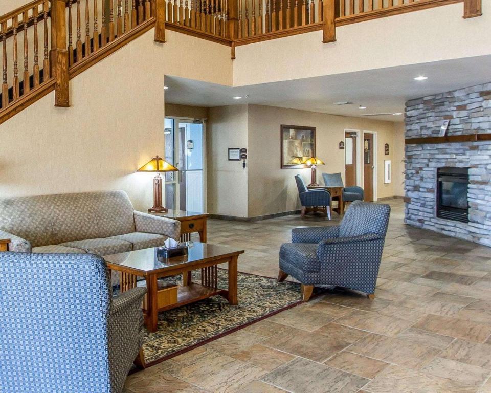 a living room with two couches and a fireplace at Quality Inn & Suites Fort Madison near Hwy 61 in Fort Madison