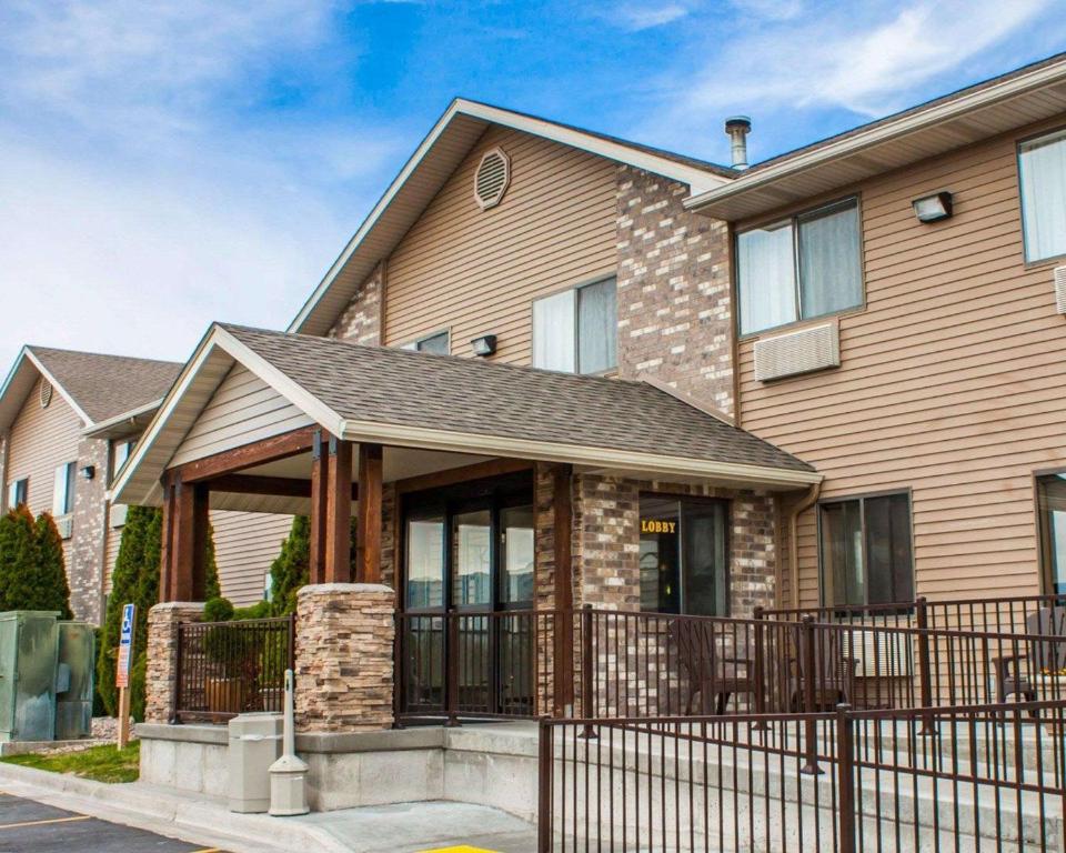 a house with a fence in front of it at Quality Inn in Pocatello