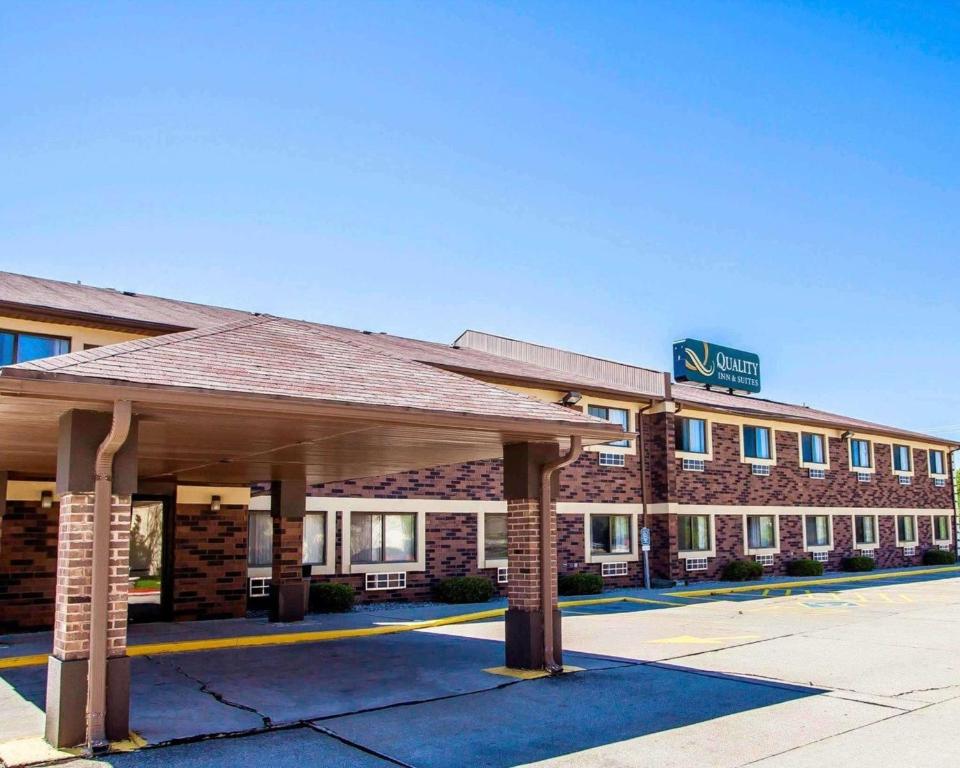 a hotel building with a pavilion in front of it at Quality Inn & Suites in Champaign