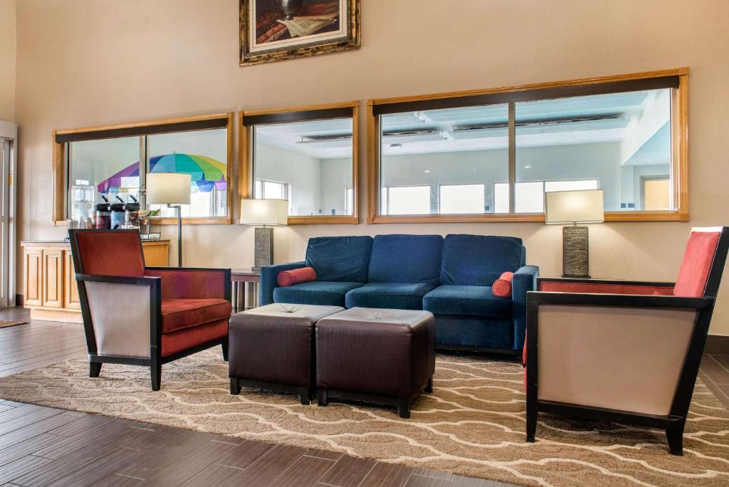 a living room with a blue couch and two chairs at Quality Inn Jacksonville near I-72 in South Jacksonville