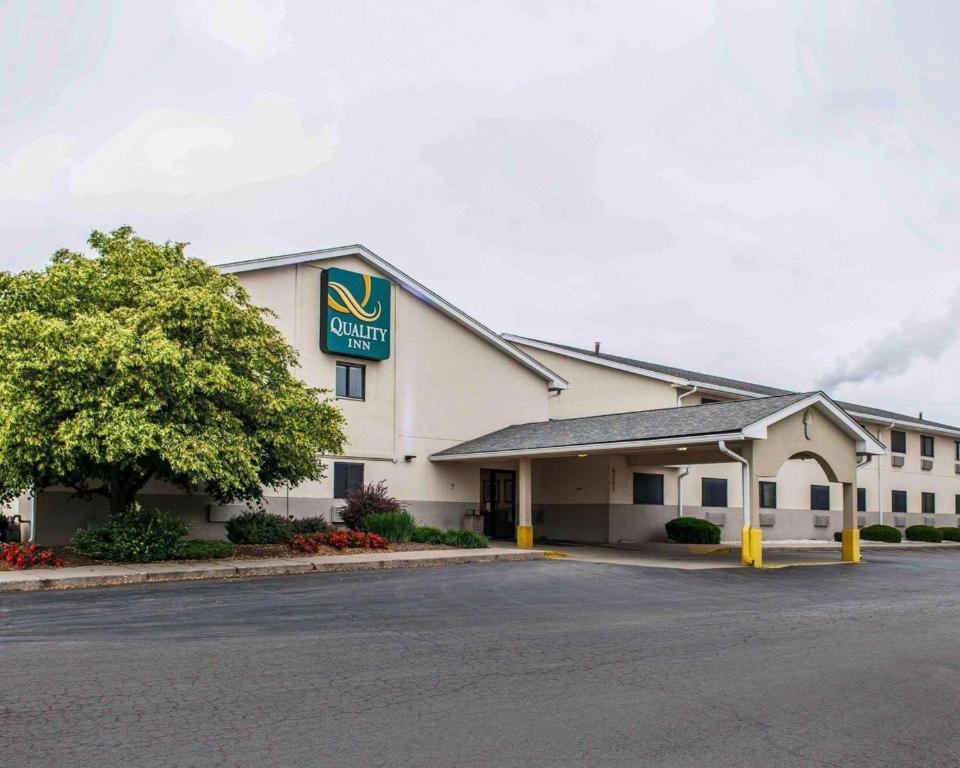 a front view of a hotel with a parking lot at Quality Inn South in Indianapolis