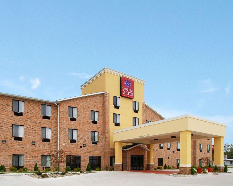 a large brick building with a clock on the front of it at Comfort Suites South Bend Near Casino in South Bend