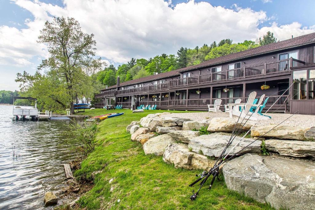 a building next to a body of water at The Black Swan Lee - Lenox, Ascend Hotel Collection in Lee