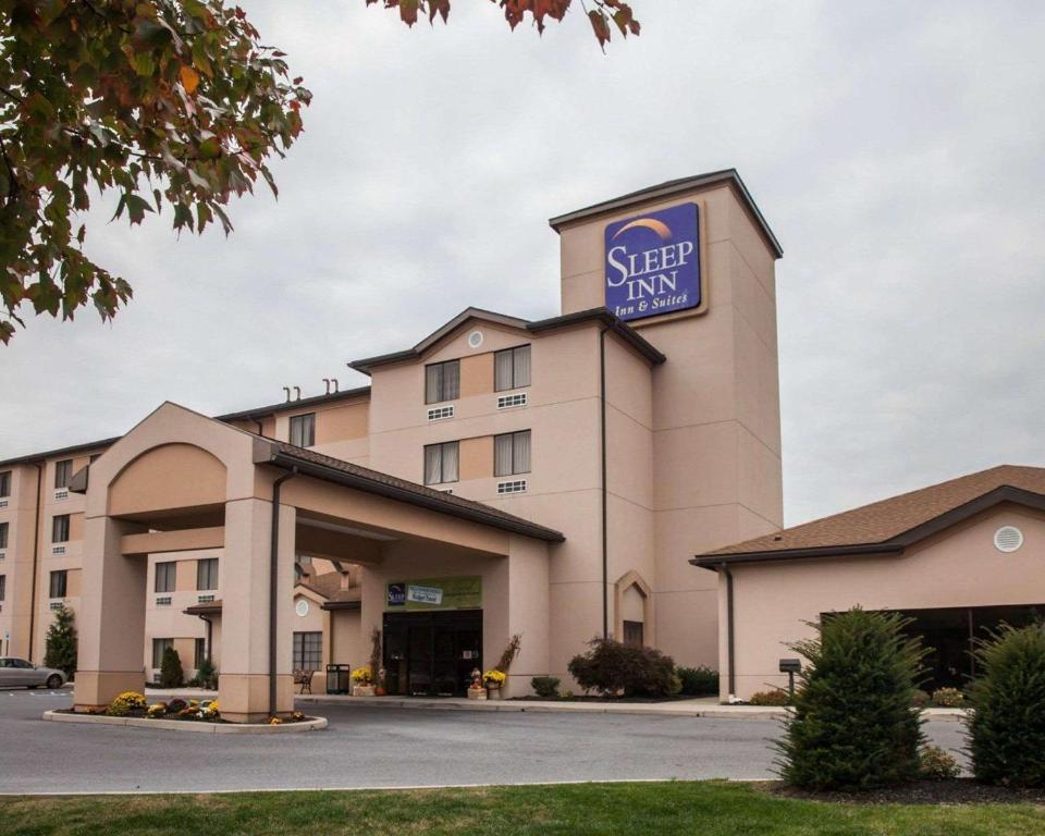a hotel with a sign on top of it at Sleep Inn & Suites Hagerstown in Hagerstown