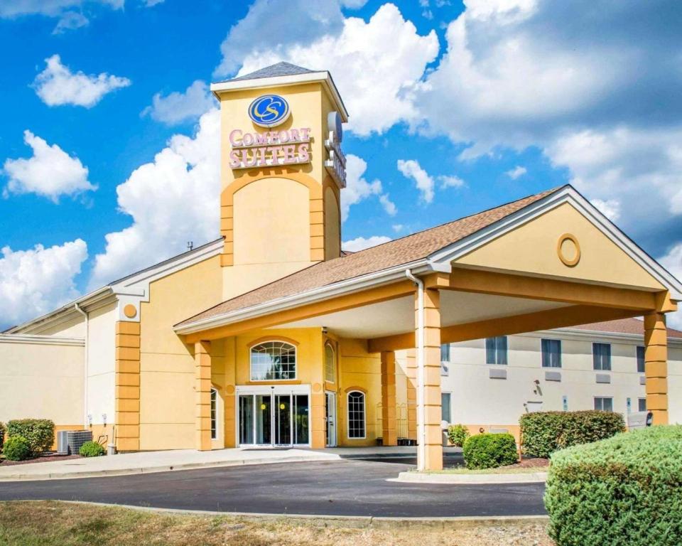 a large yellow building with a clock tower at Quality Suites in Waldorf
