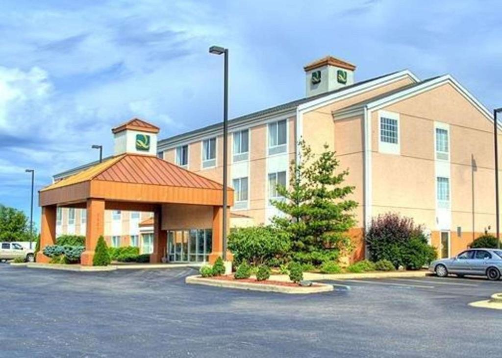 a large building with a car parked in a parking lot at Quality Inn I-94 near Wings Stadium in Kalamazoo