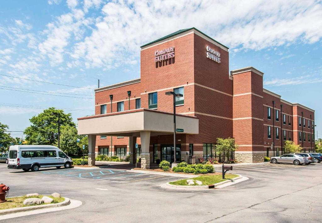 カントンにあるComfort Suites Canton - Detroitの駐車場に車を停めた建物