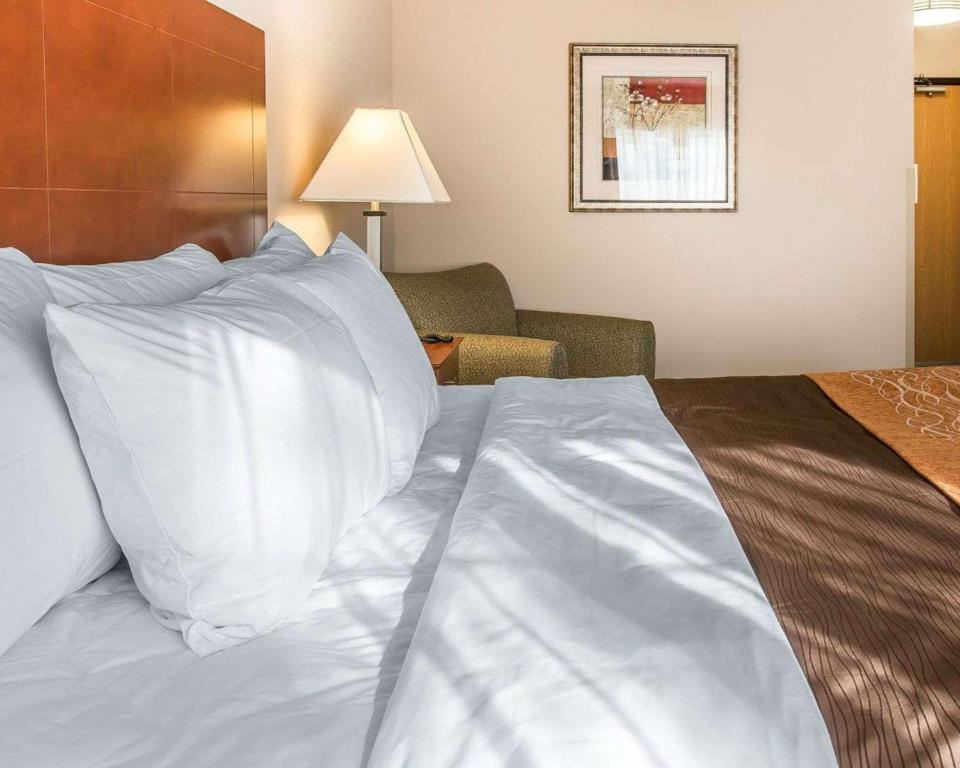a large bed with white pillows in a hotel room at Quality Inn Near Interstate I94 in New Buffalo