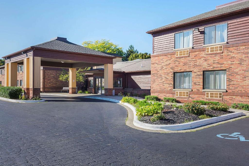 a brick building with a driveway in front of it at Quality Inn & Suites Holland in Holland