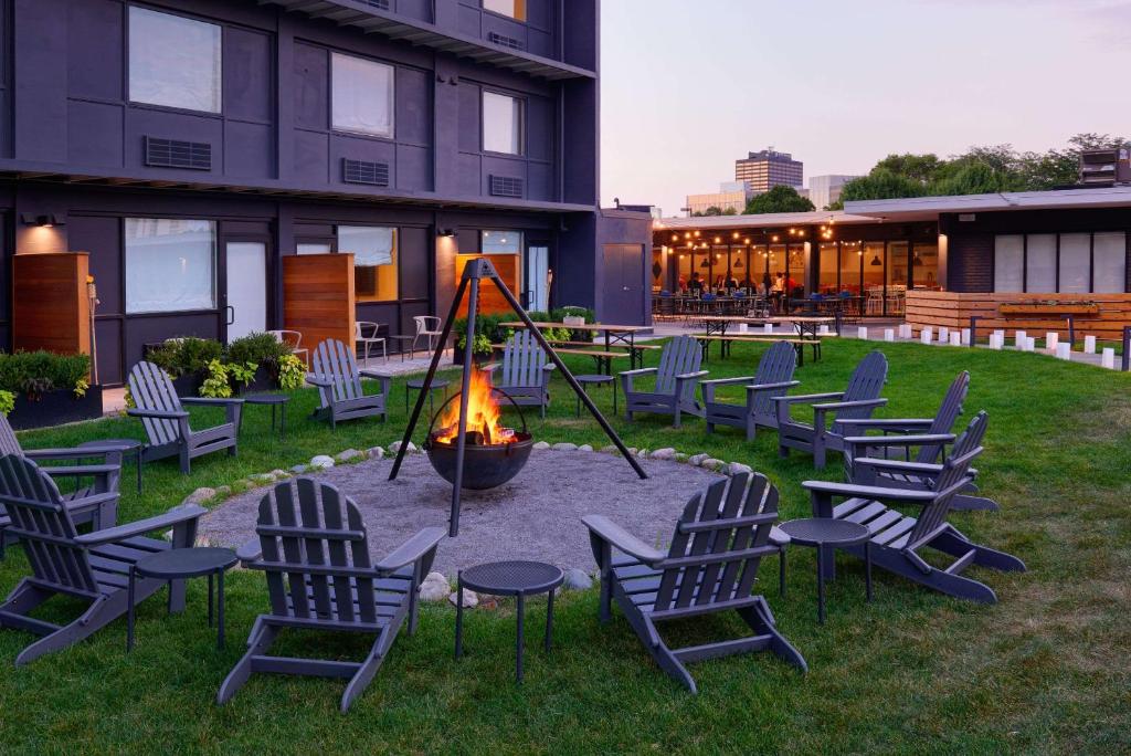 a group of chairs and a fire pit in a yard at Trumbull and Porter - Detroit Downtown in Detroit