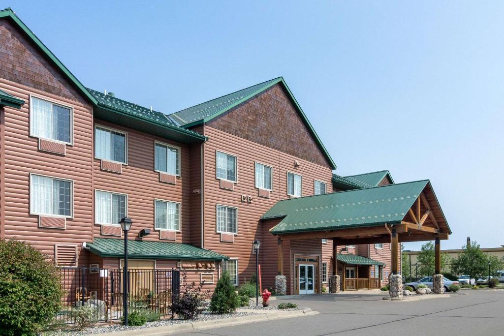 a large brown building with a green roof at Rapid River Lodge in Baxter