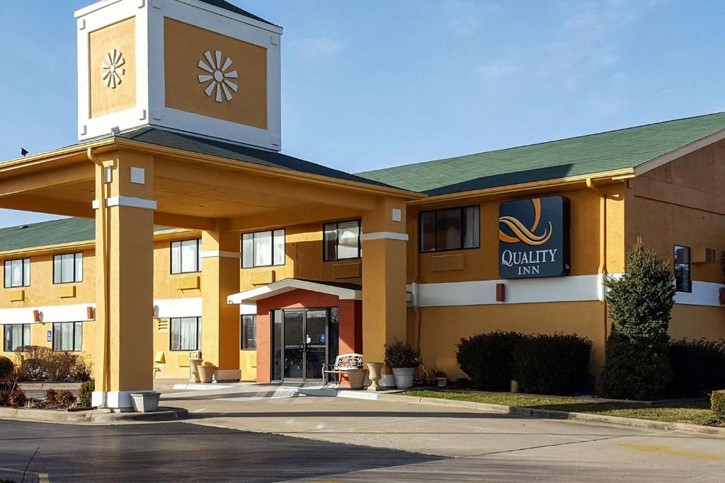 a large building with a clock on the front of it at Quality Inn Ozark in Ozark