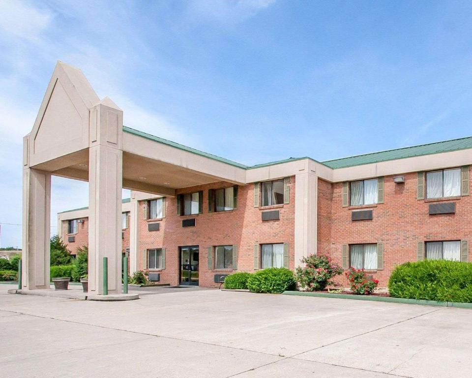 a large red brick building with a large entrance at Econo Lodge in Dexter