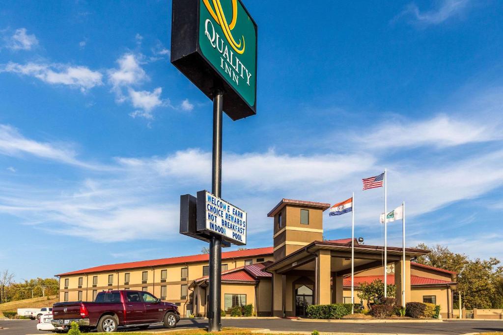 a sign on a pole in front of a hotel at Quality Inn in West Plains