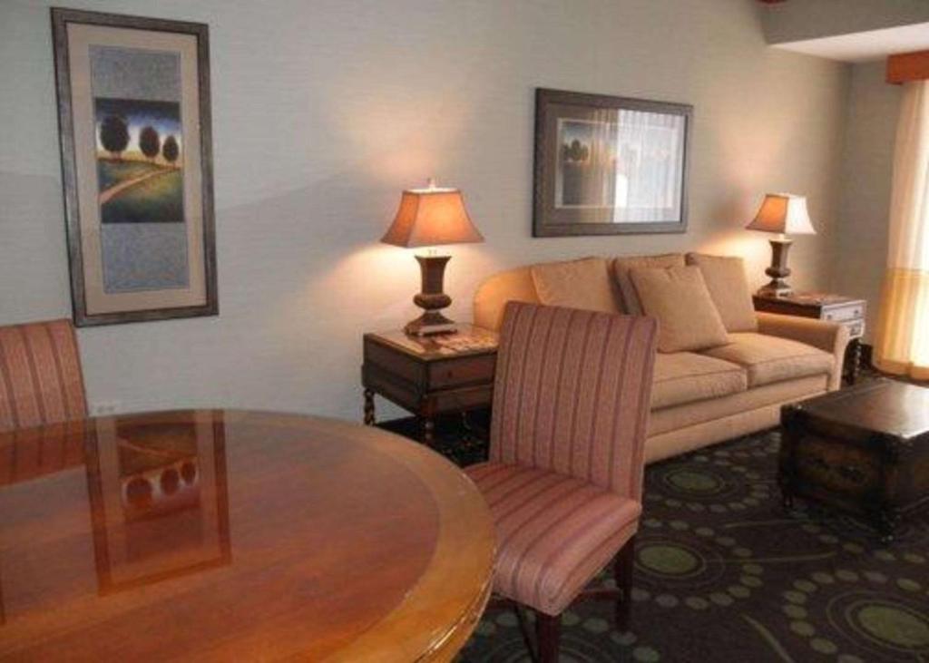 a living room with a couch and a table at Quality Inn Florissant-St Louis in Florissant