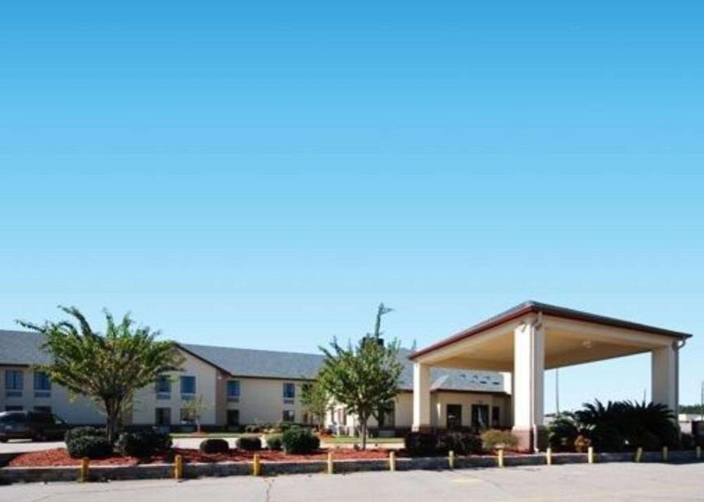 a gas station with a pavilion in front of a building at Columbia Inn & Suites in Columbia