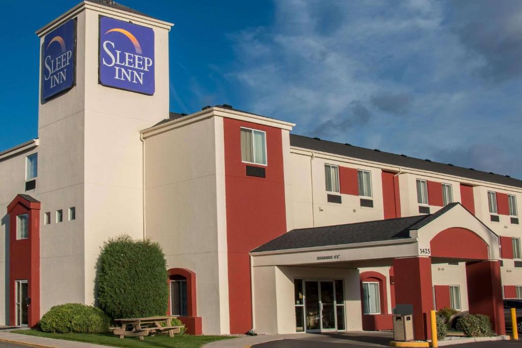 a hotel with a sign on top of a building at Sleep Inn Missoula in Missoula