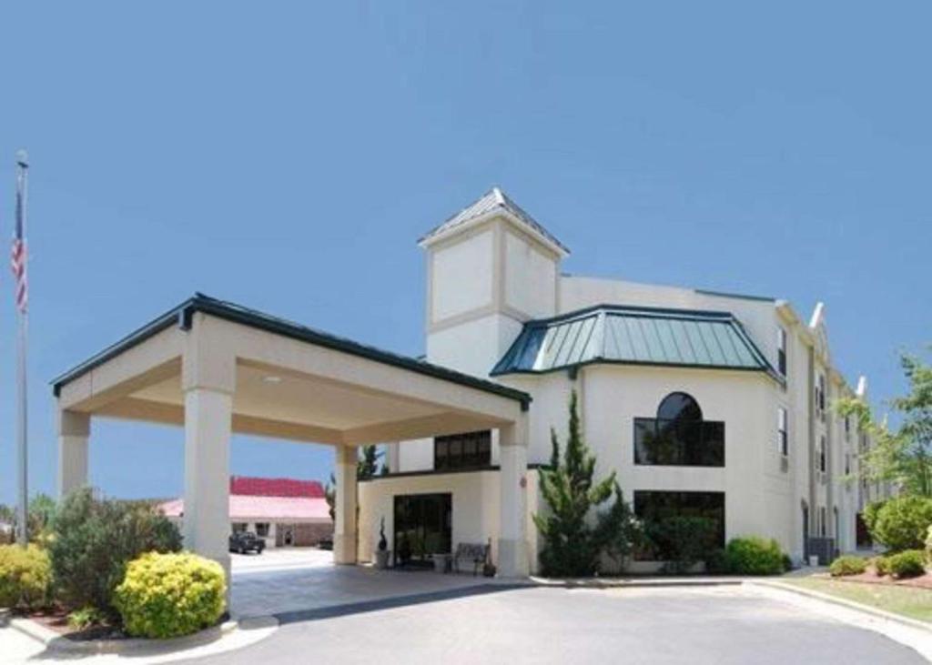 un grand bâtiment blanc avec un parking couvert dans l'établissement Quality Inn & Suites Tarboro - Kingsboro, à Tarboro