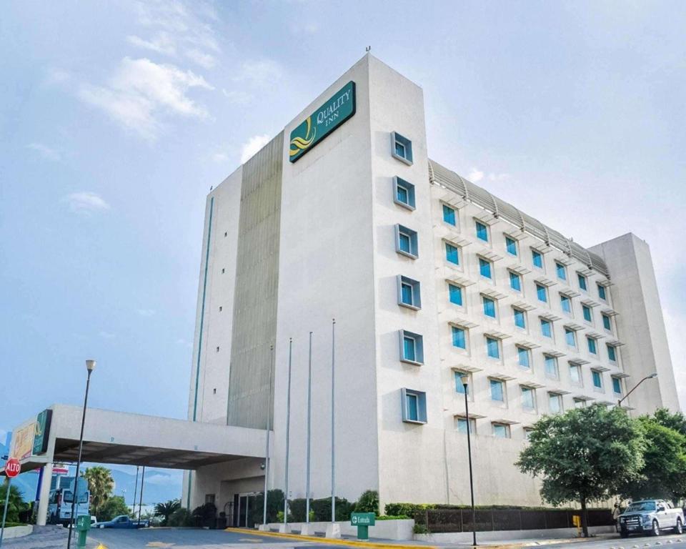 a large white building with a sign on it at Quality Inn Monterrey La Fe in Monterrey