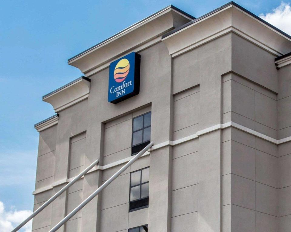 a building with a sign on the side of it at Comfort Inn & Suites in Lumberton