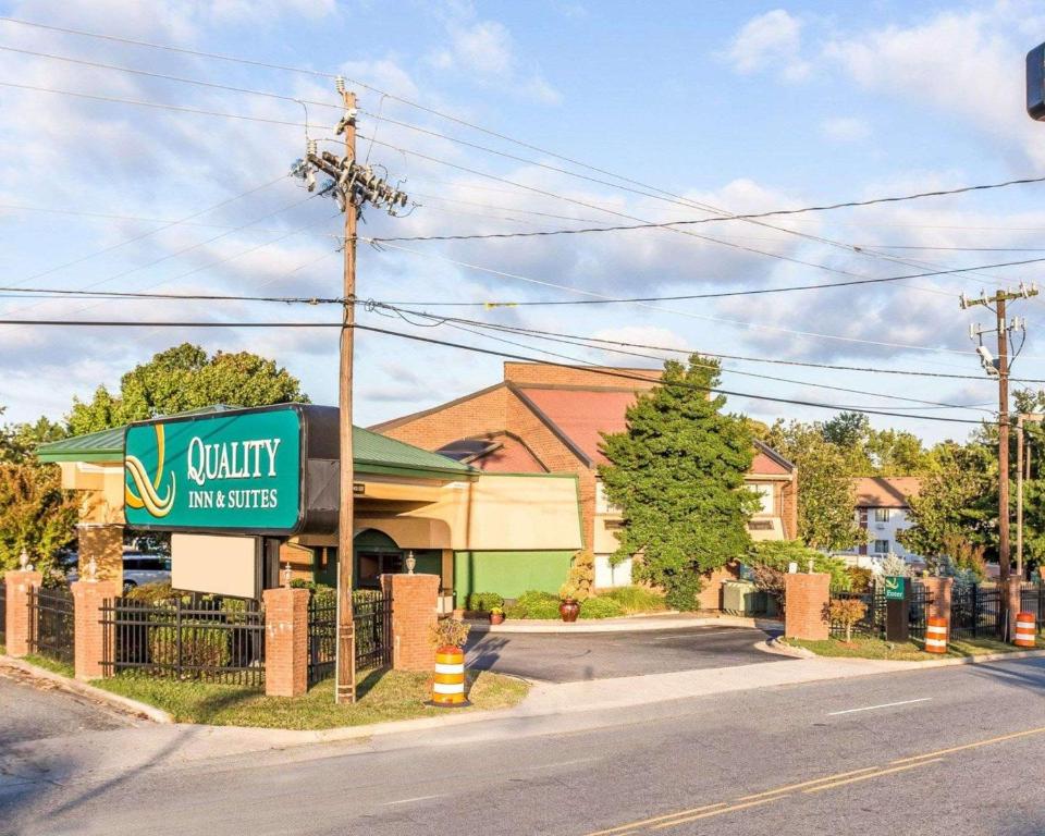 a building with a sign for a quality inn suites at Quality Inn & Suites Coliseum in Greensboro