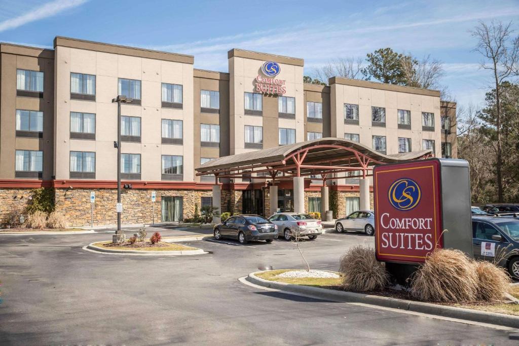 a hotel with a sign in front of a building at Comfort Suites New Bern near Cherry Point in New Bern