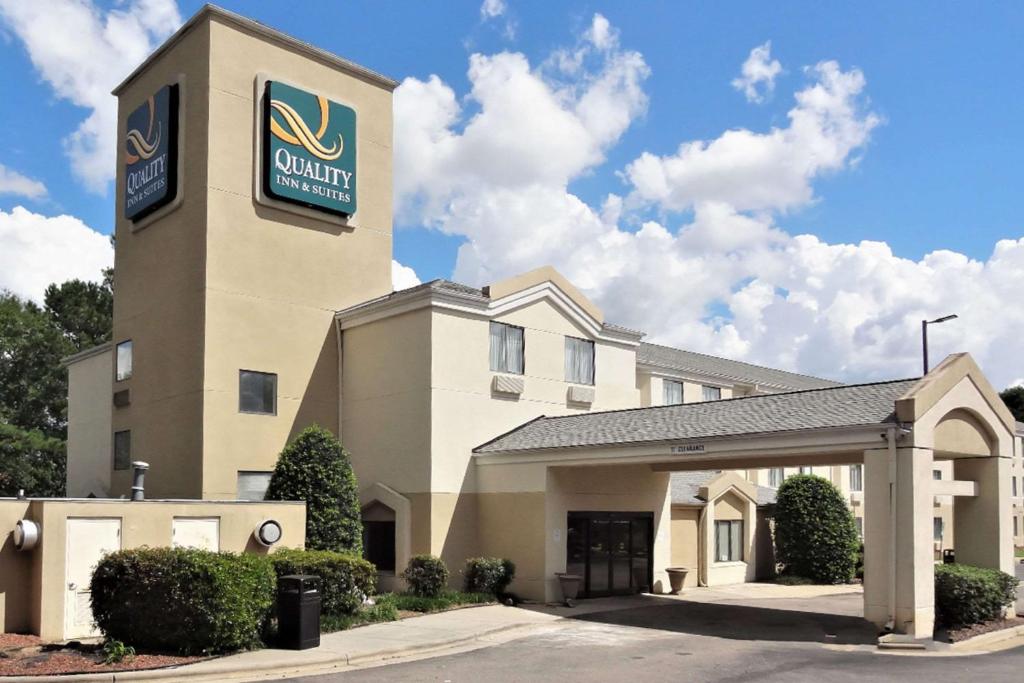 a hotel with a sign on the front of a building at Quality Inn & Suites Raleigh North Raleigh in Raleigh