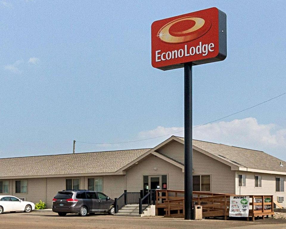 a sign in front of a building with a colomburger at Econo Lodge in Jamestown