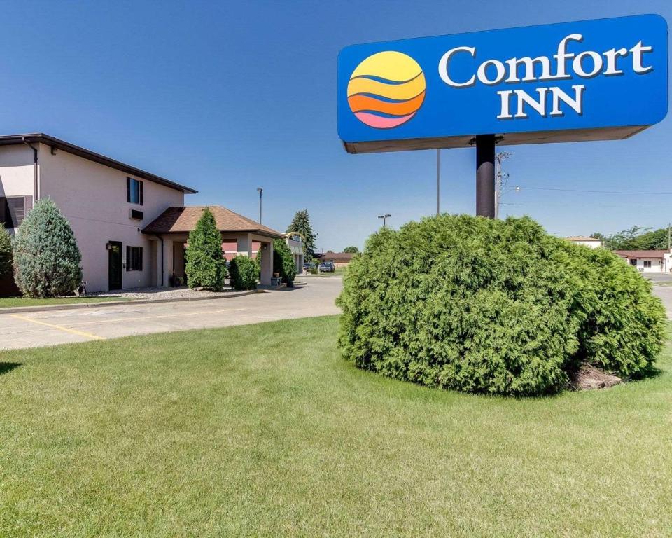 a sign for a comfort inn in front of a bush at Comfort Inn in Jamestown
