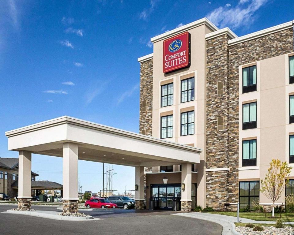 a hotel with a sign on the front of a building at Comfort Suites Fargo Medical Center in Fargo