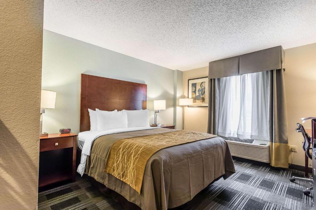 a hotel room with a bed and a window at Comfort Inn SW Omaha I-80 in Omaha