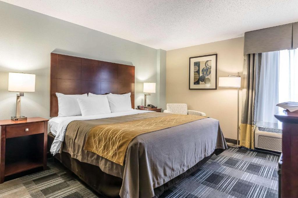 a hotel room with a bed and a window at Comfort Inn SW Omaha I-80 in Omaha