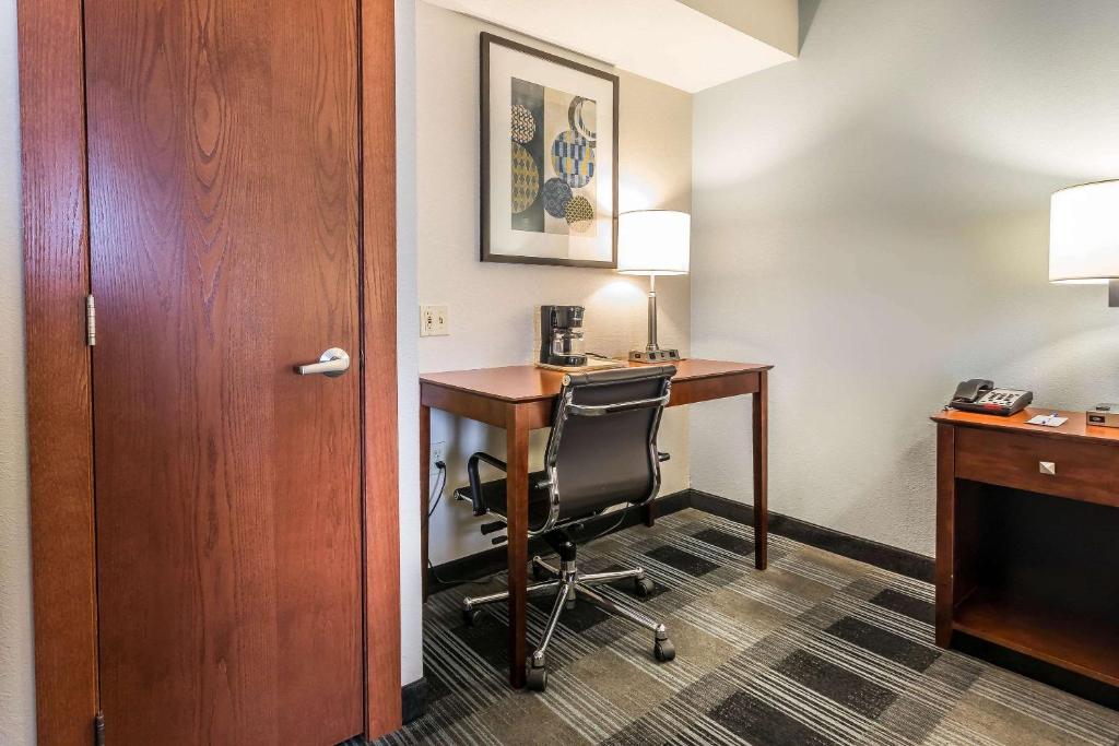 a hotel room with a desk and a chair at Comfort Inn SW Omaha I-80 in Omaha