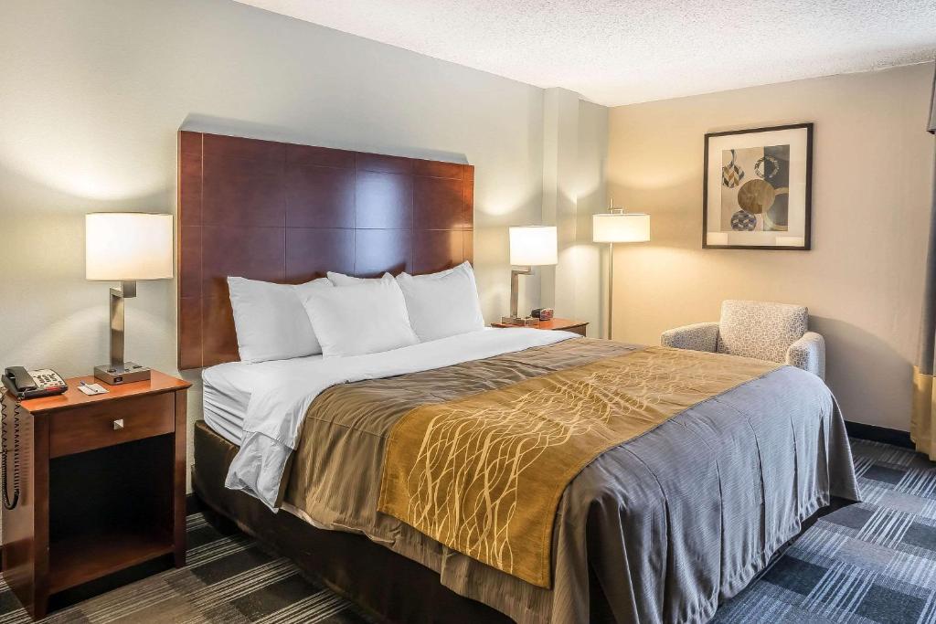a hotel room with a bed and a chair at Comfort Inn SW Omaha I-80 in Omaha